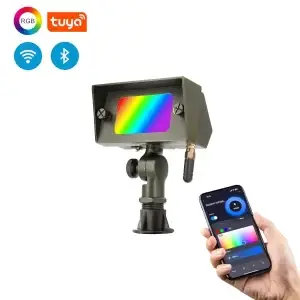 die-cast brass wash light showing coloring changing on the lens. Hand with a phone showing the TUYA appear appears from the corner showing color changing options. Icons on the top right show Wifi and Bluetooth compatible, Tuya app and the RGB option.