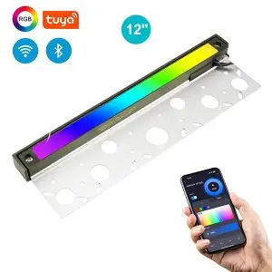 A 12" brass hardscape light with stainless steel mounting brackets and smart color changing options via wireless connectivity, as denoted by a hand holding a phone with the options available visible on screen at the bottom right and icons showing the various functionalities in the top left of the image.